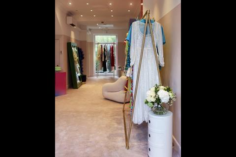 Racks of brightly coloured clothes in store at By Rotation, Belgravia